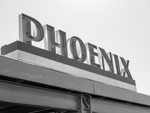 Professional technician performing AC repair Phoenix home outdoor condenser unit