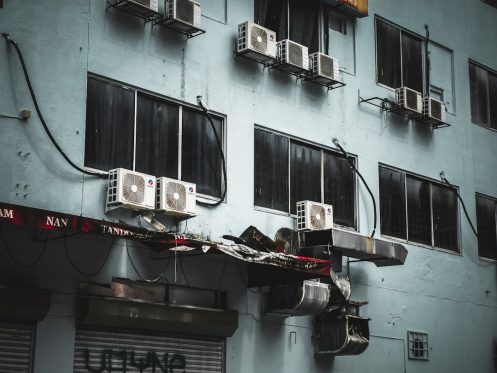 Emergency AC repair technician working on broken air conditioner unit in Phoenix