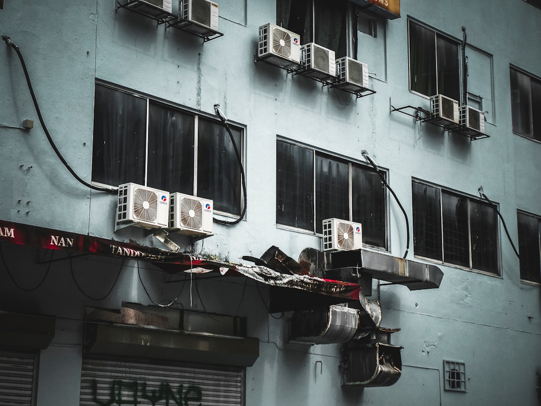 Emergency AC repair technician working on broken air conditioner unit in Phoenix